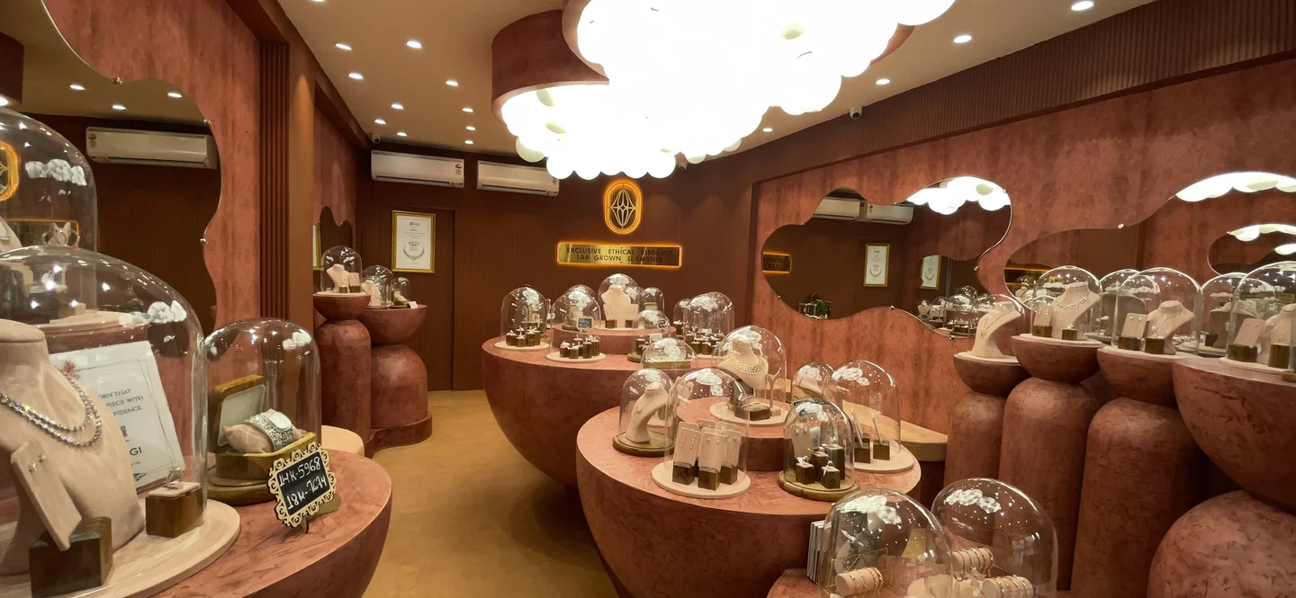 Inside Aurique, with curved mirrors, glowing lights and lab-grown diamond jewellery under glass